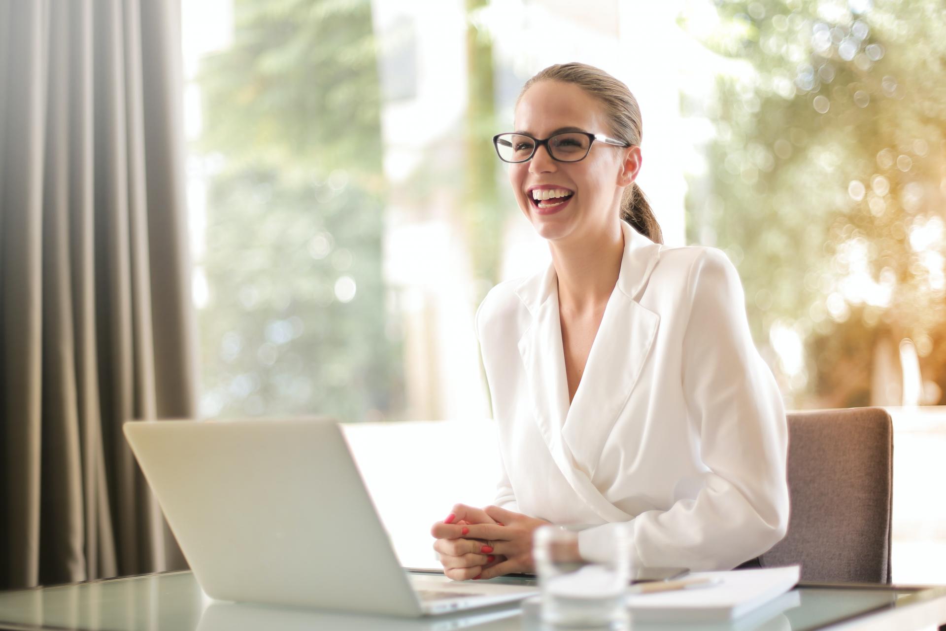 Smiling woman sitting at her computer