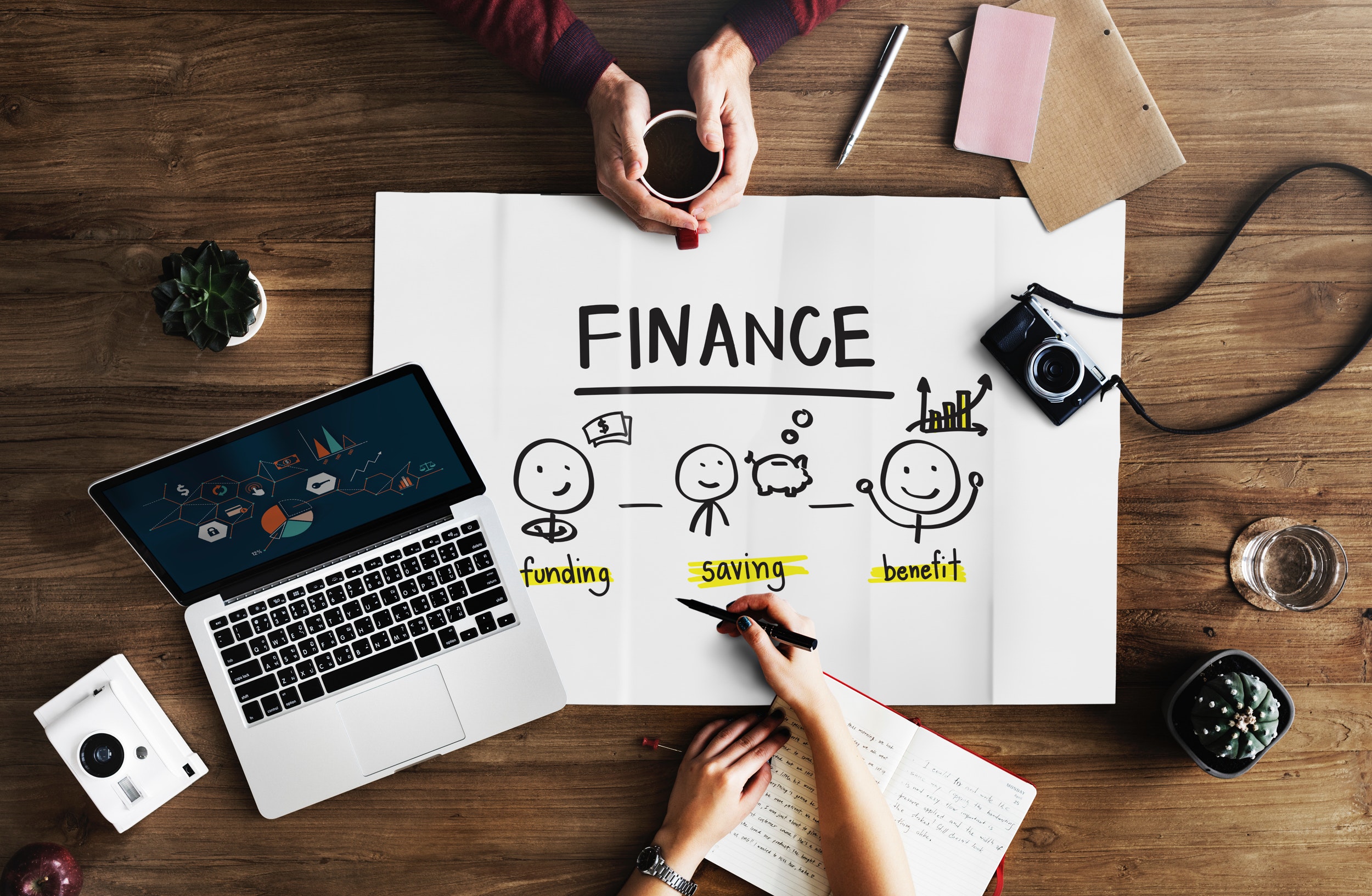 Two people at a desk discussing finance.