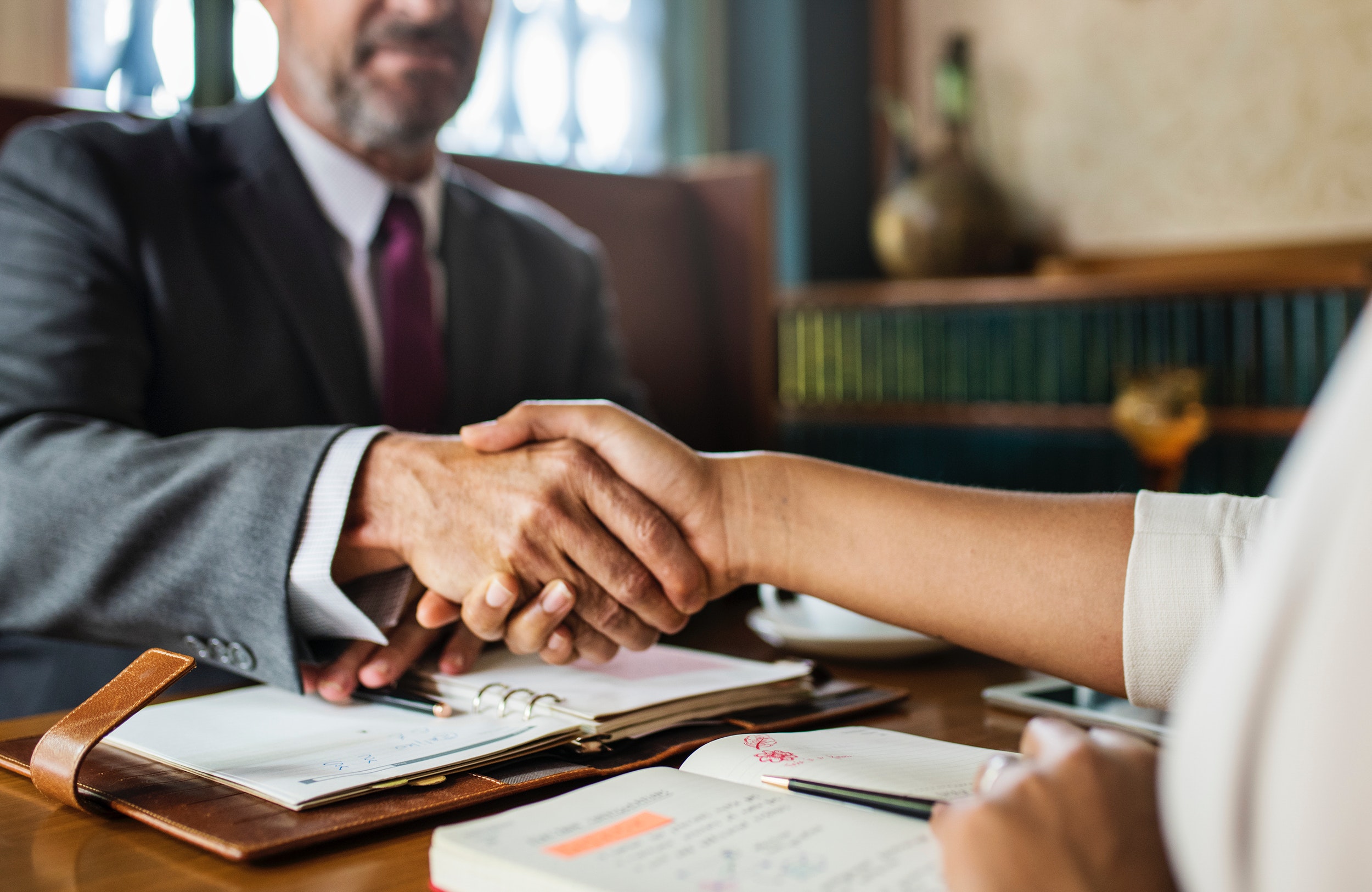 A CPA shakes hands with his client.
