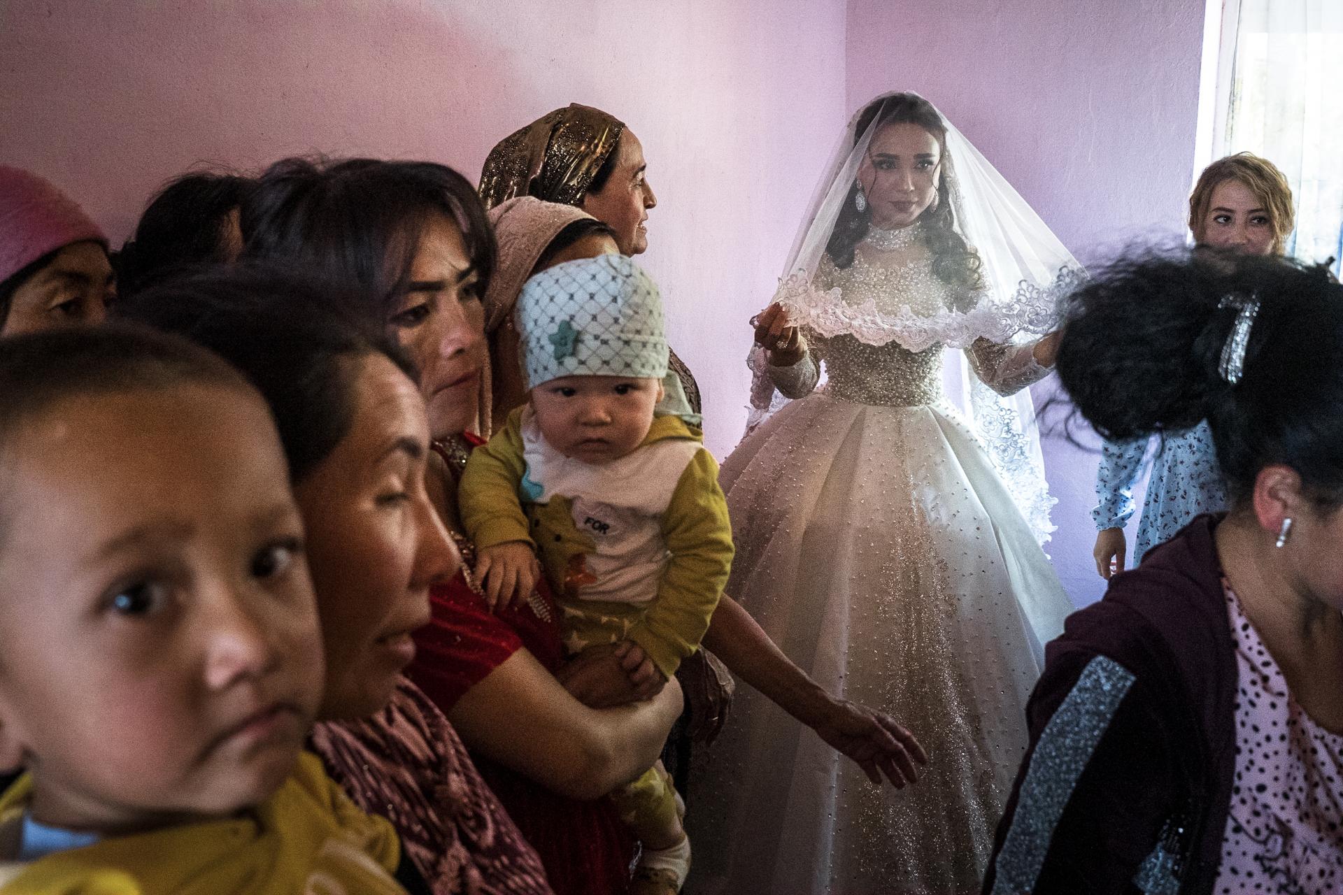 Guests gather around bride at cultural celebration - exclusive Raw Tours photo tour experience in Uzbekistan.