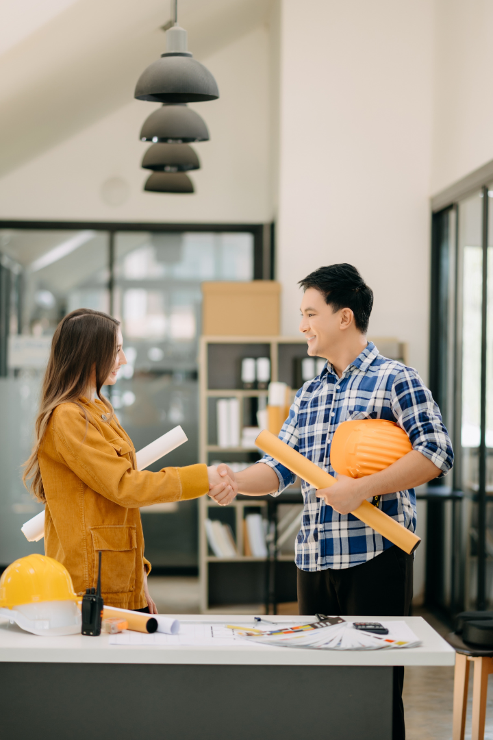 Two construction engineers shaking hands