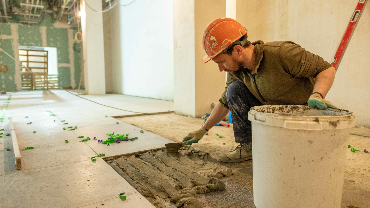Construction worker installing tiles