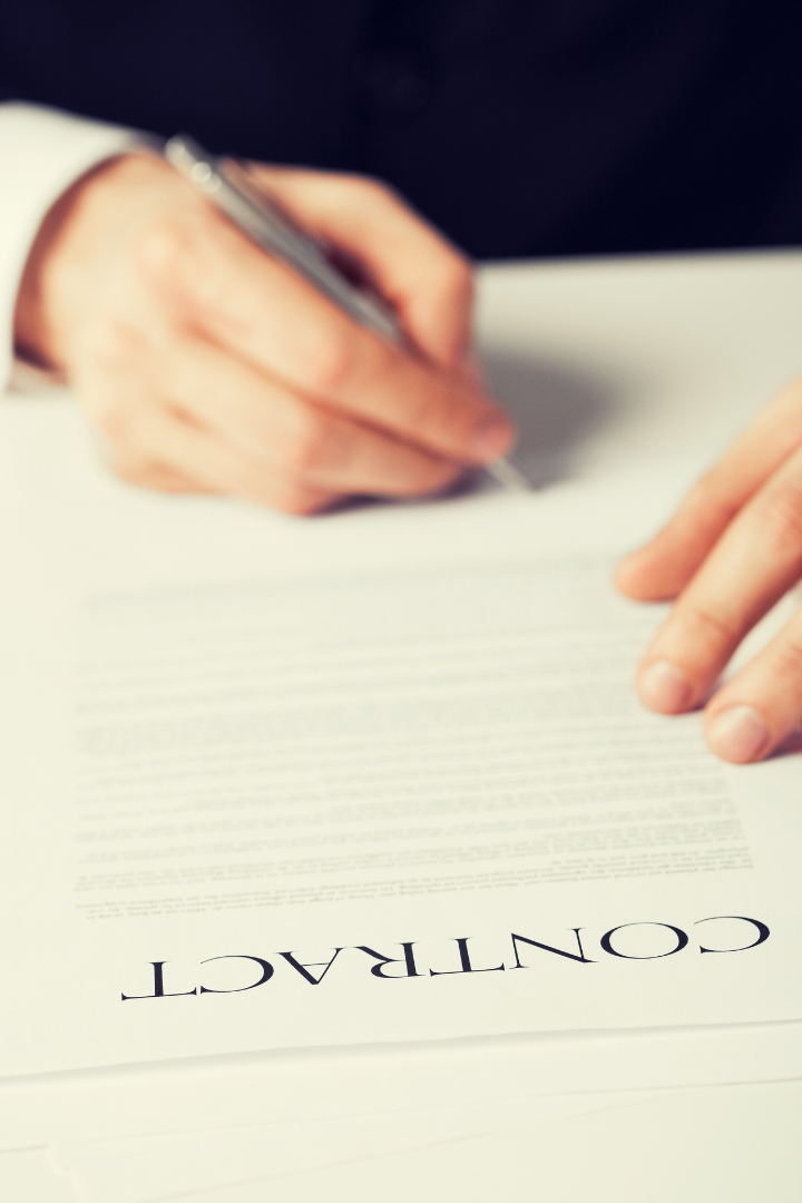 Hand of a man signing a contract