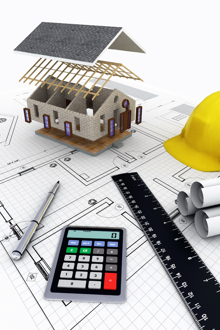 Image of house construction concept and a blueprint on a table with tools and calculator