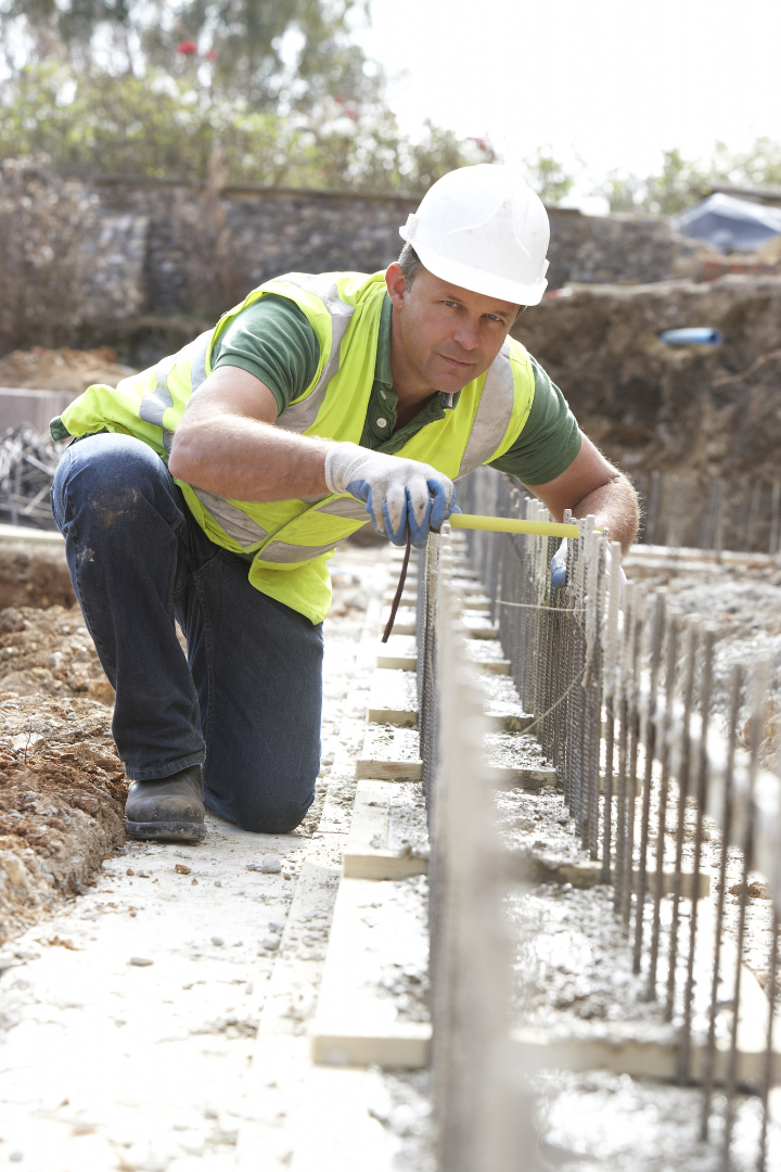 Cement worker laying foundation