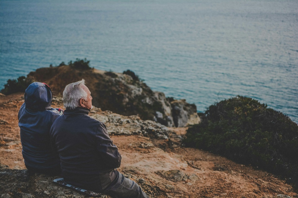 Senior couple starring at the sea