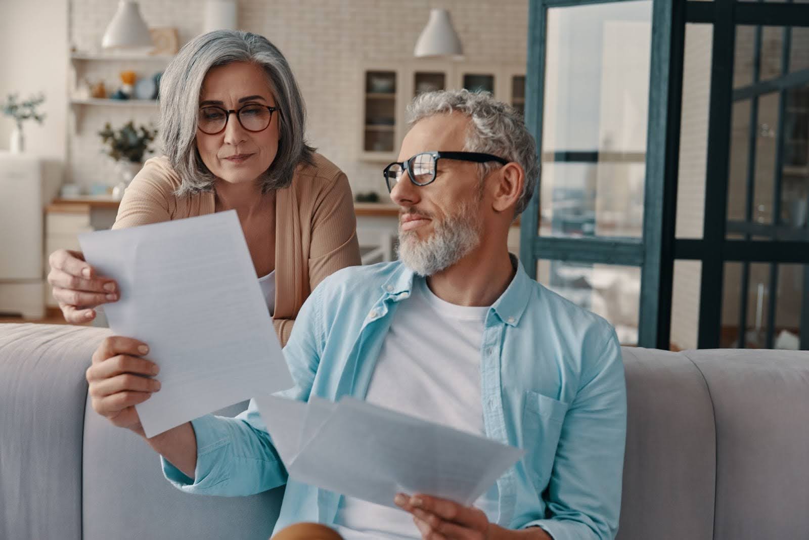 a senior couple checking documents
