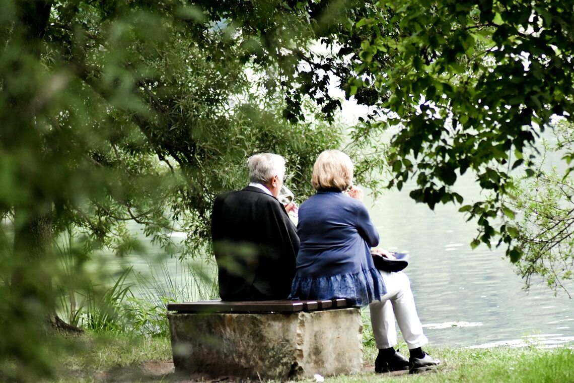 two people sitting on a bench
