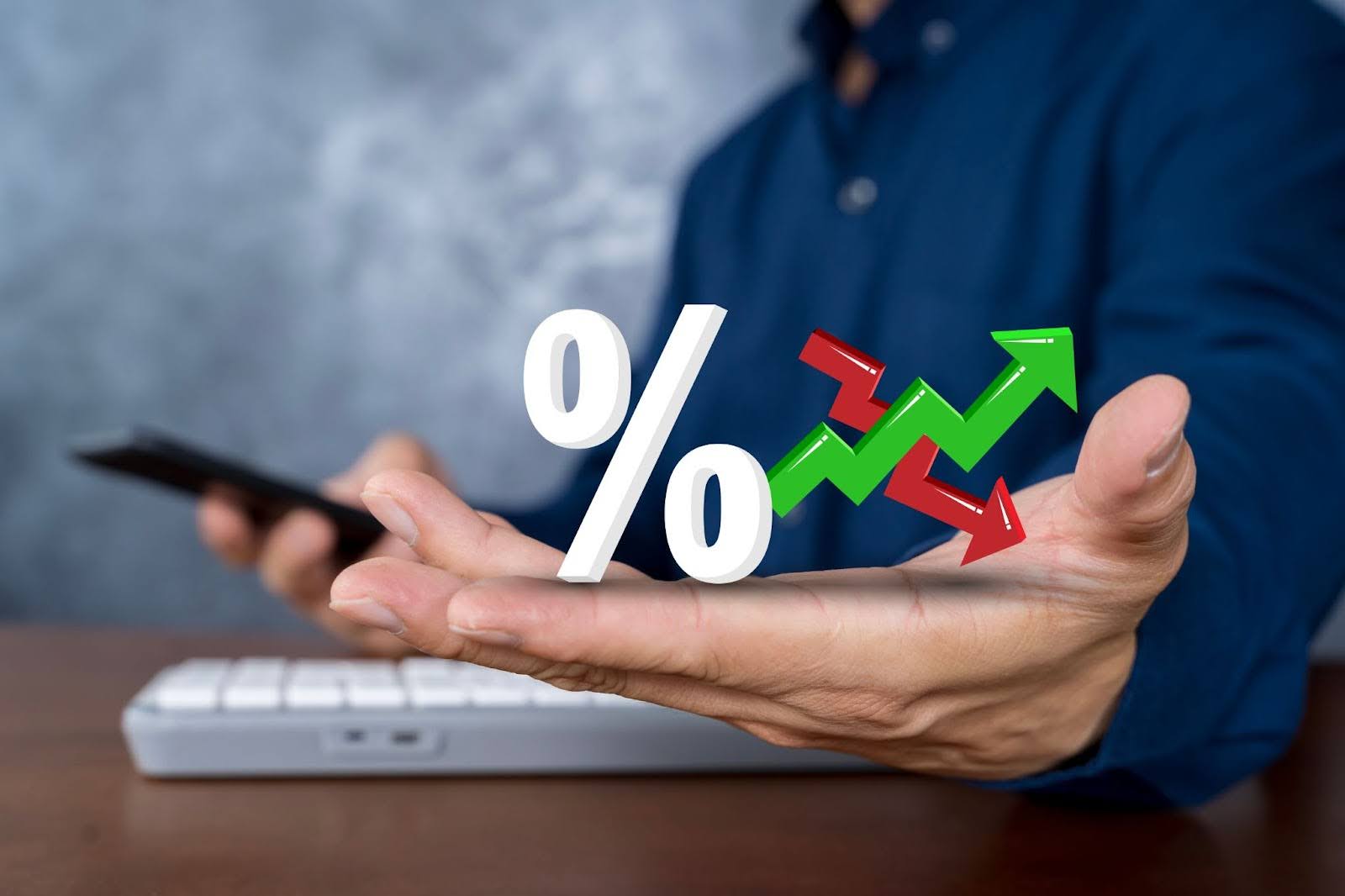 a man showing symbols of green up and red down arrows, and a percentage sign 
