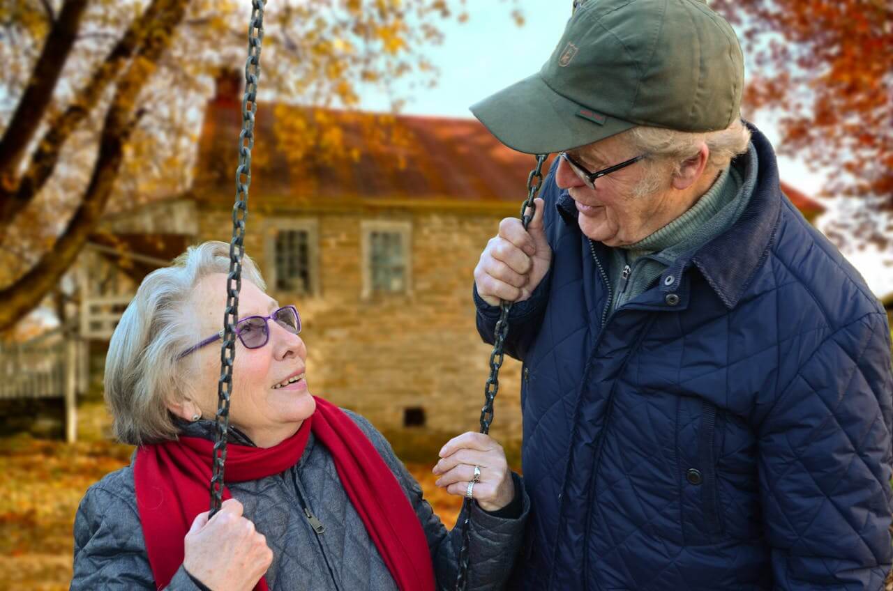 Senior couple enjoying a moment on a swing during retirement