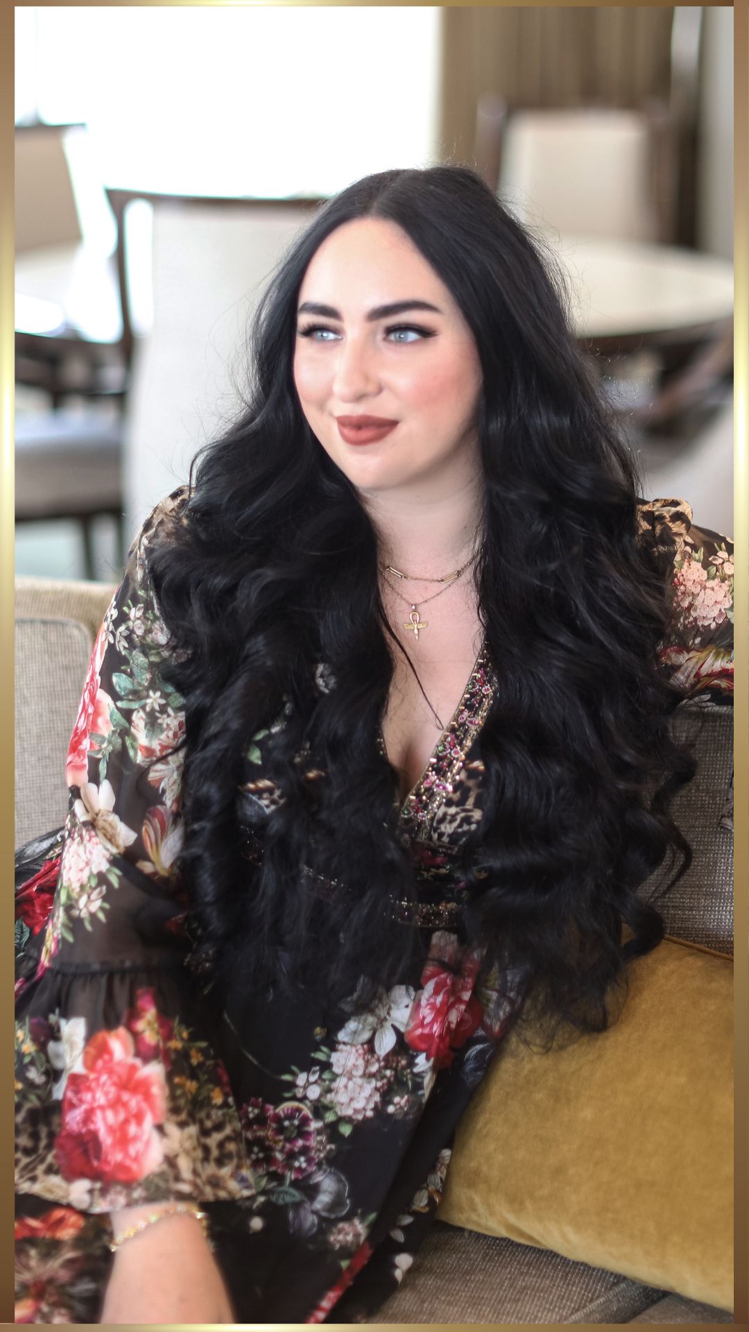 Athina Bailey sitting on chair with crossed legs.