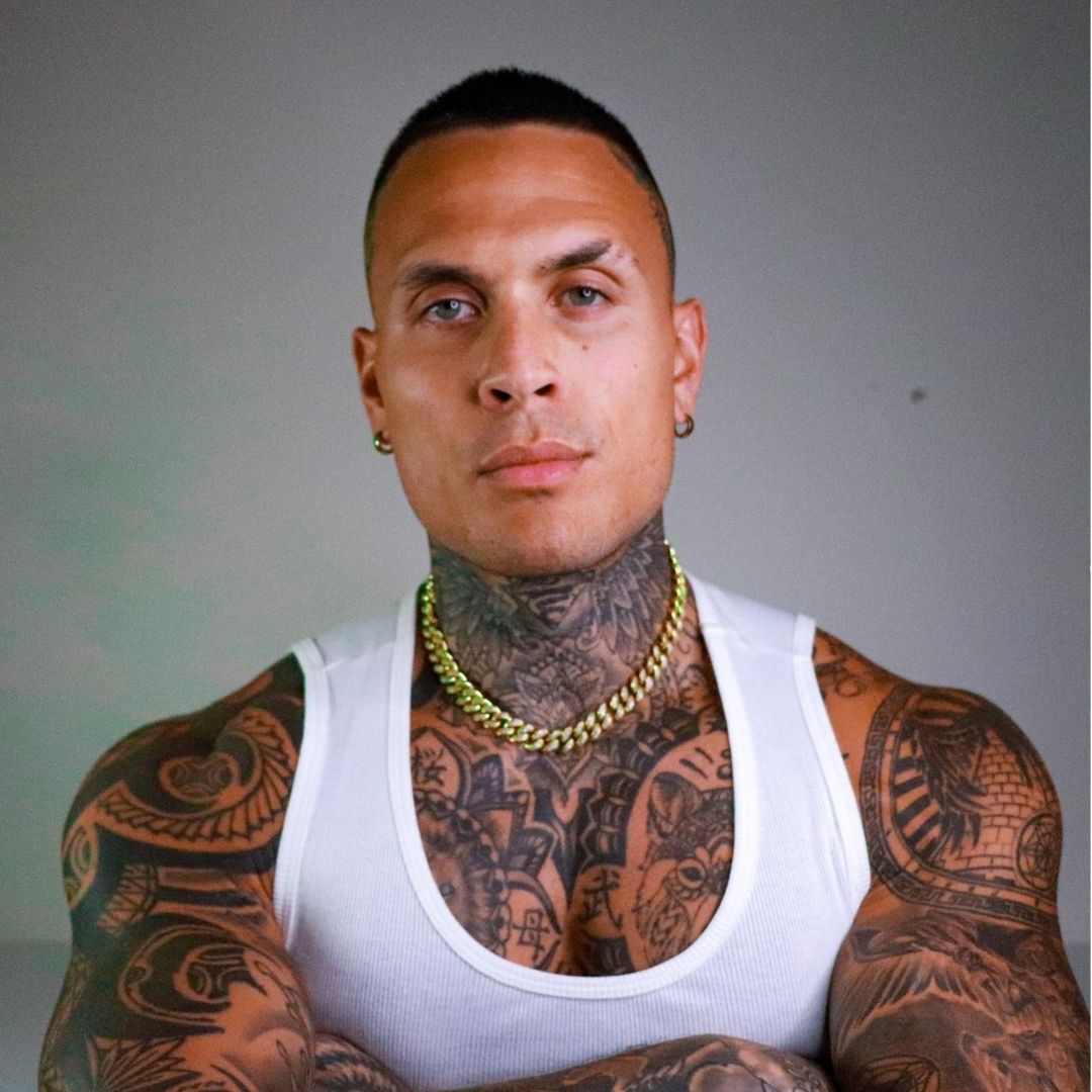 A stylish woman wearing a pink shirt and red pants, looking confident and fashionable.