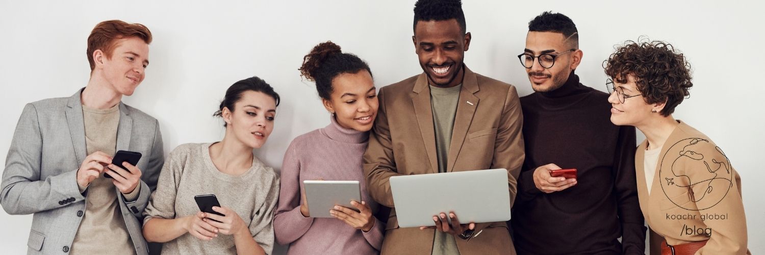 A group of impact consultants huddling together, sharing resources