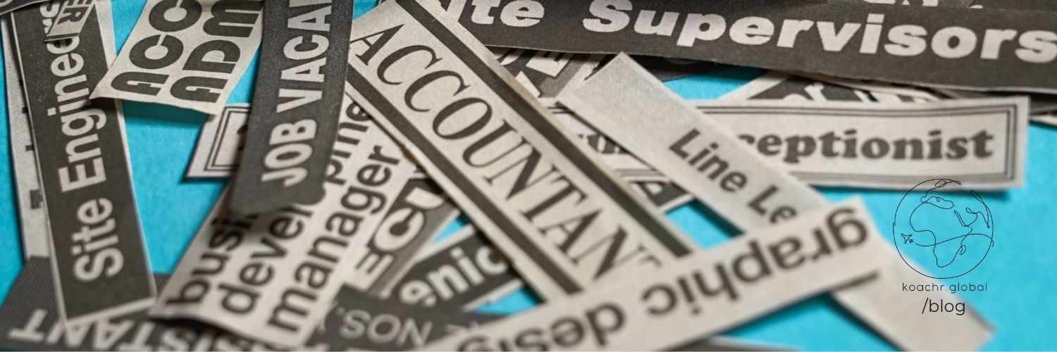 Newspaper clippings with various job titles in a messy pile