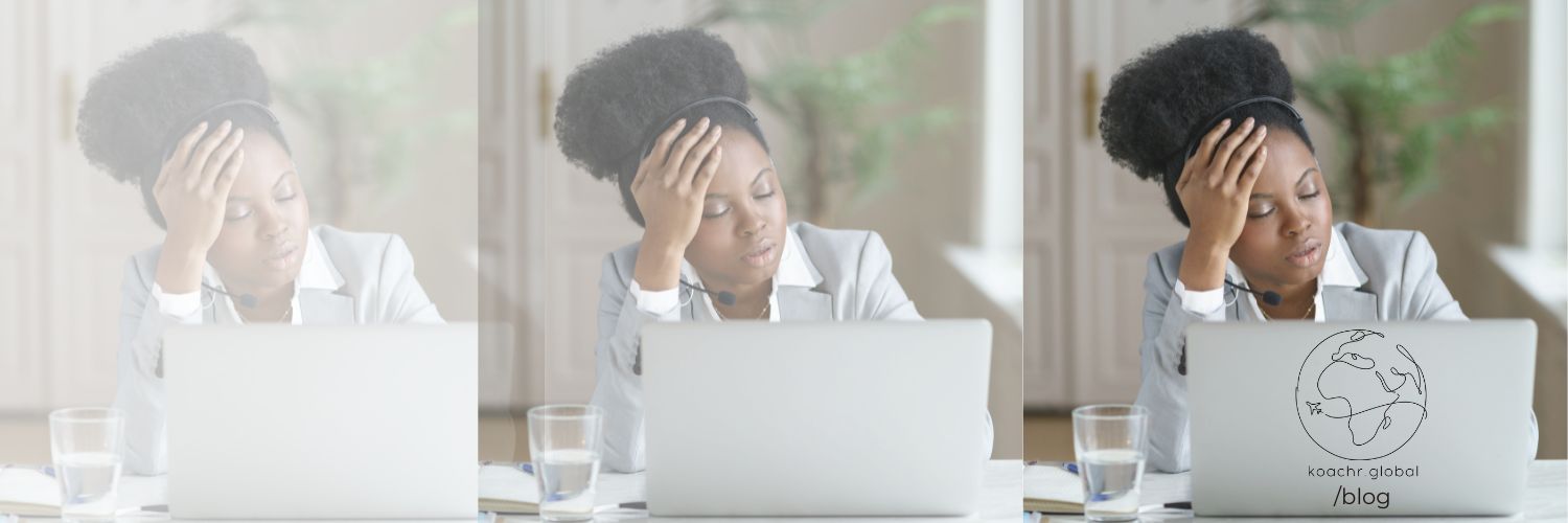 Woman at computer, looking tired from duplicating tedious work.
