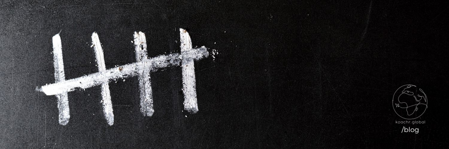 5 chalk marks on a blackboard