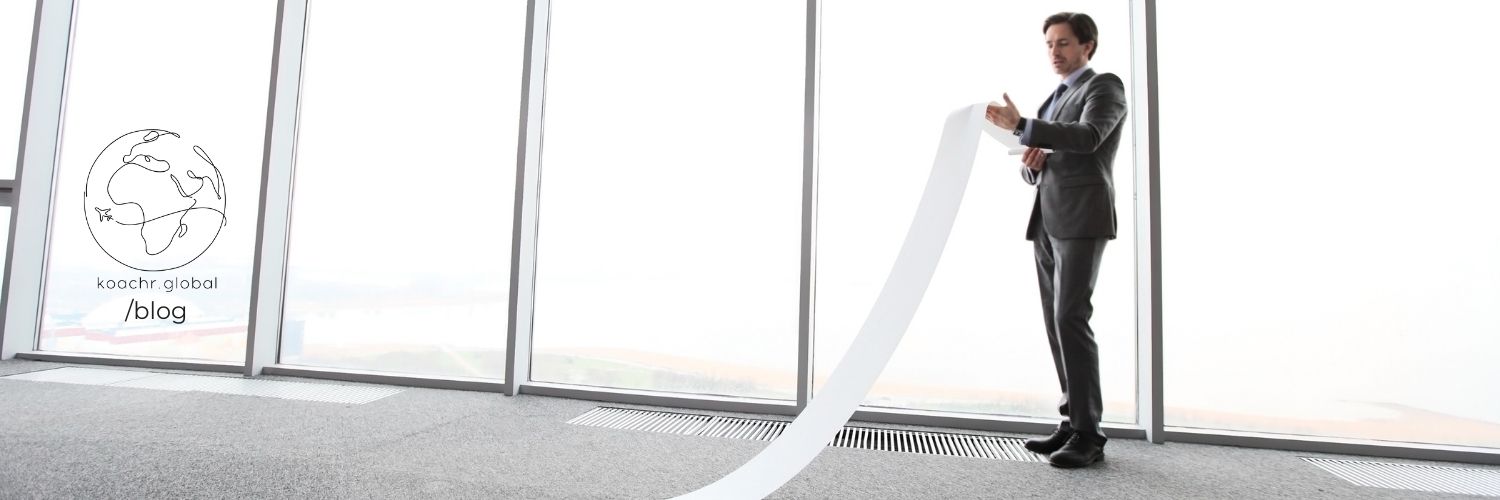 Man reading from a paper that is seemingly endless - like some UN applications!