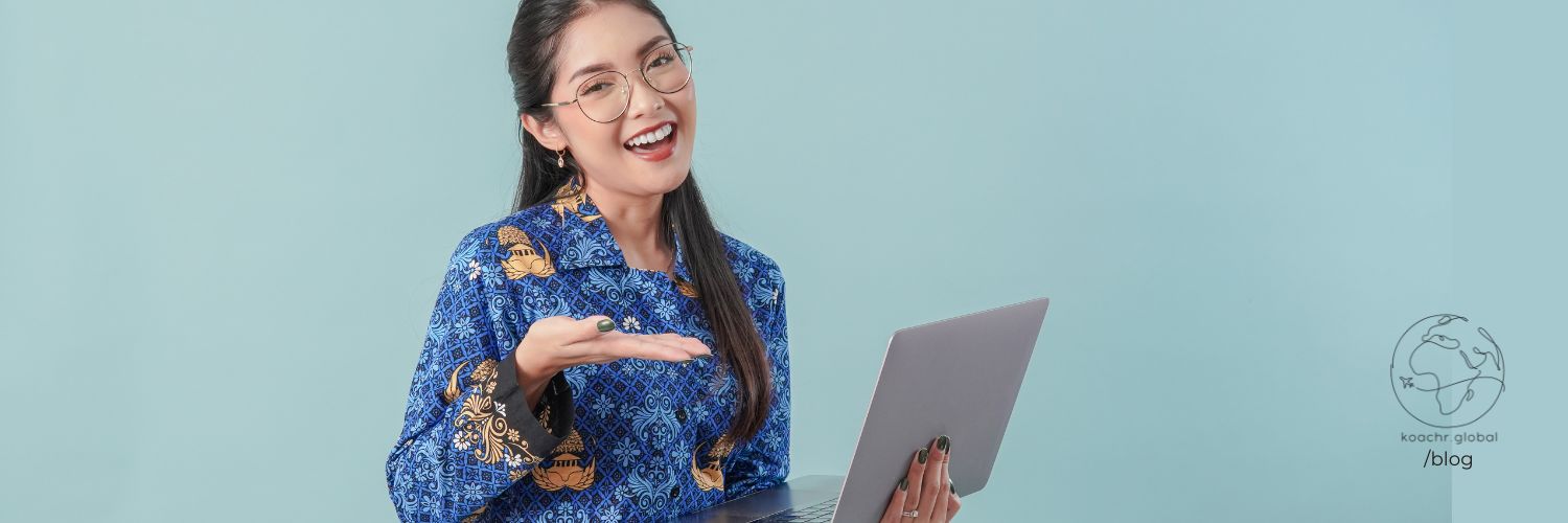 Woman holding her laptop, looking excited about a new resource she just found out about.