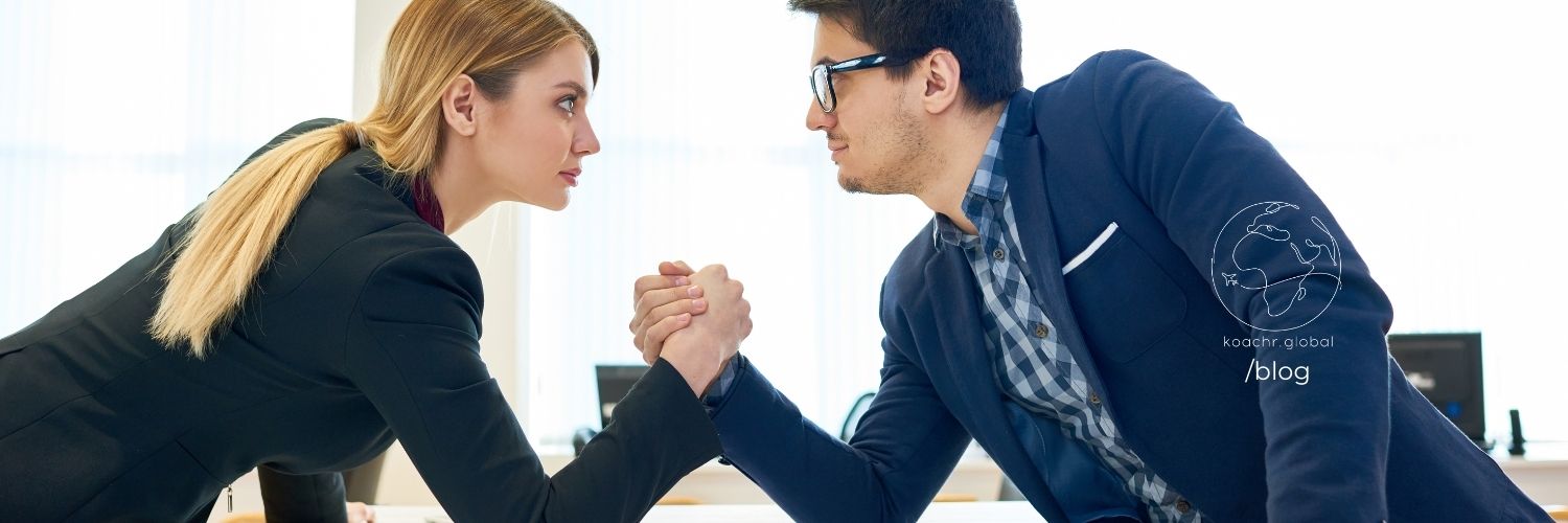 Two job candidates arm wrestling, illustrating their respective competitive advantages