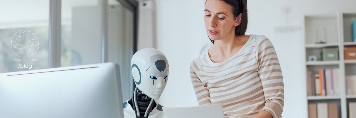 Woman showing documents to a robot sitting at a computer.