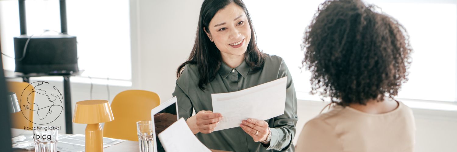 Two women engaging in conversation with curiosity.