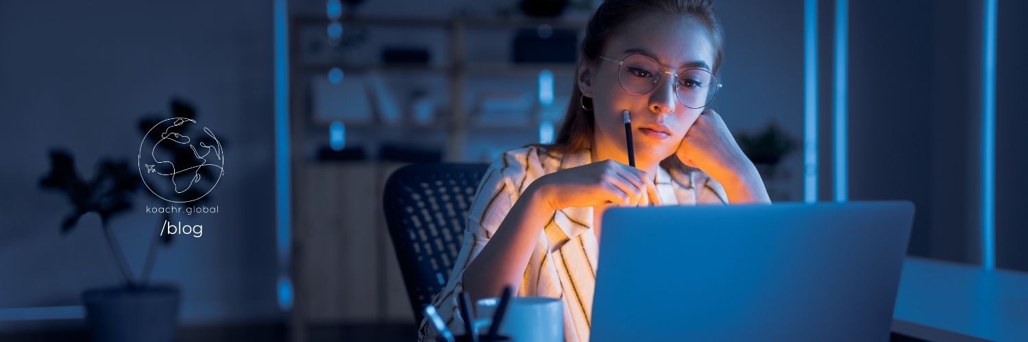 Woman working on UN job applications on her computer late into the night.