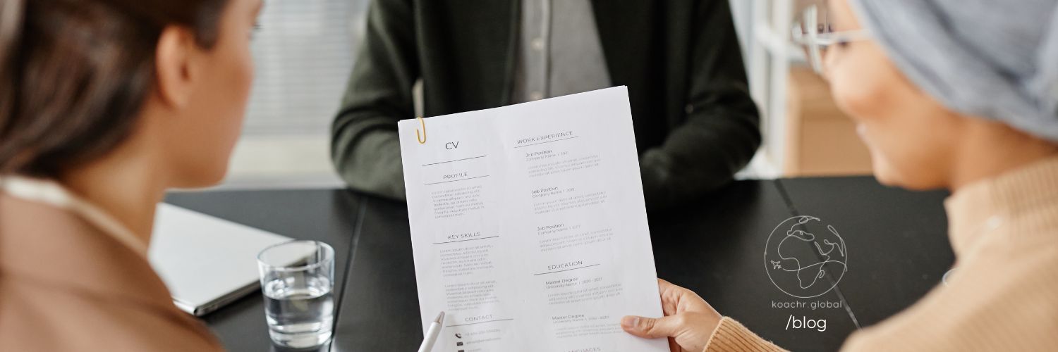 Two recruiters looking at a candidate's CV together