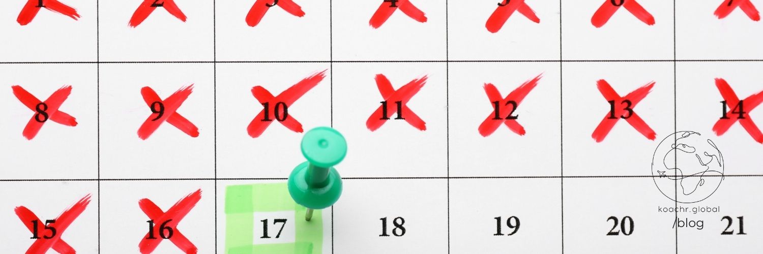 Calendar with days crossed out and a pin on a day when the goal was reached.