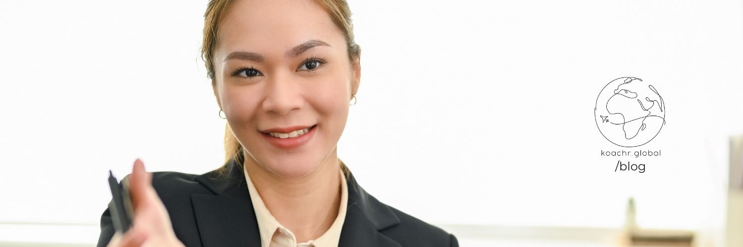 Recruiter reaching out her hand to greet a candidate.