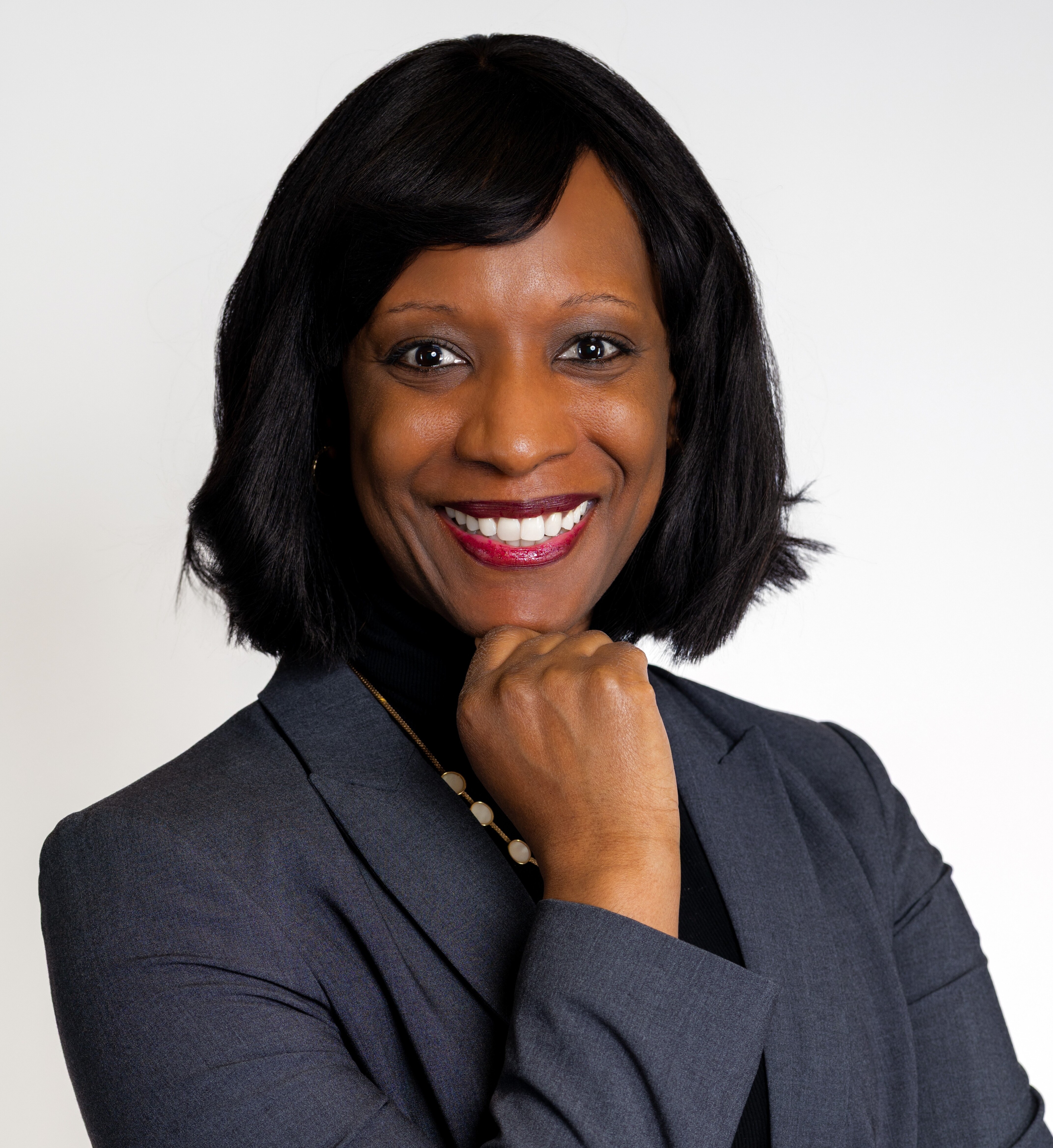 Rhodes Perry headshot - white man with a big smile, arms crossed, glasses, short beard, bald