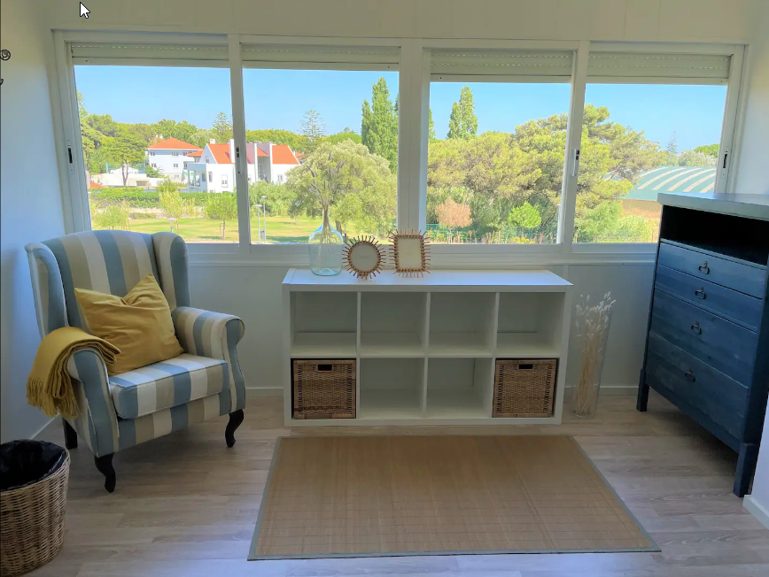 woman reflecting at a desk as she looks out on the mountains below