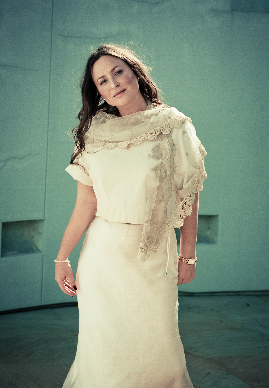 Kay Clarity, presenter and singer, stands artfully in white