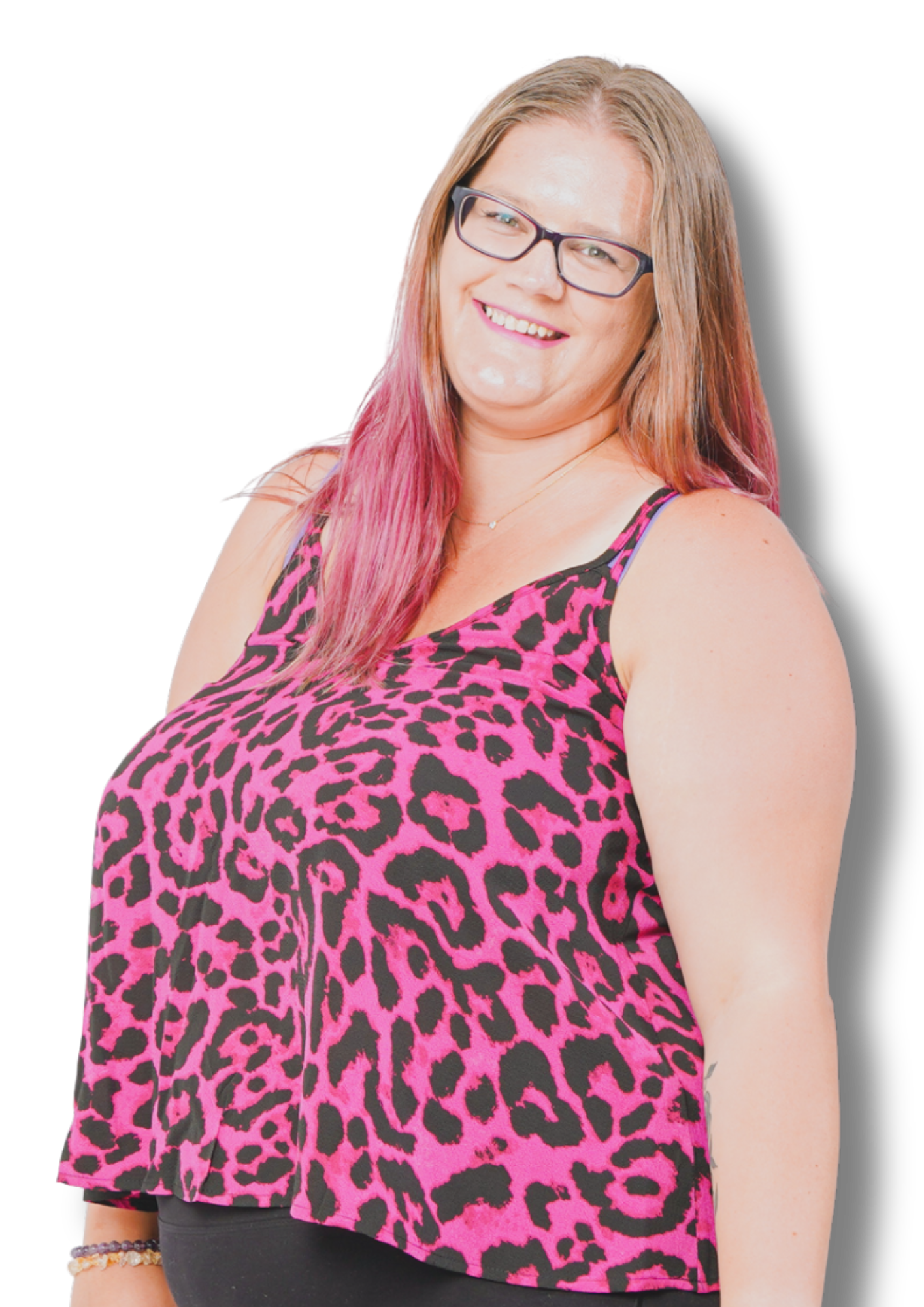 dani smiling with long, straight hair partially dyed pink, wearing black glasses and a sleeveless pink leopard print