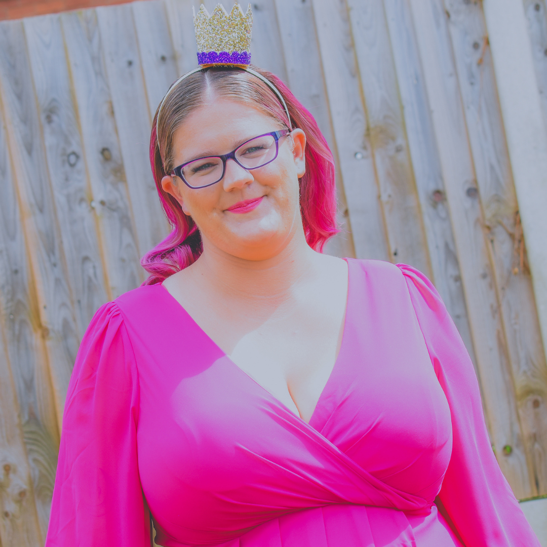 Dani, female business coach and mentor with blonde hair with pink ends, holding a coffee