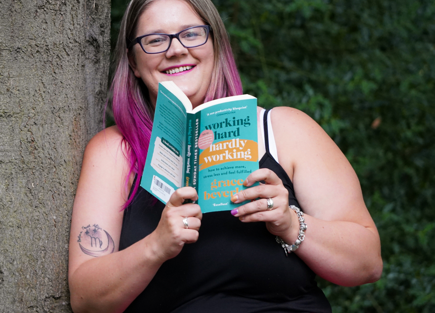 Business coach enjoying a book on productivity and balance while relaxing outdoors