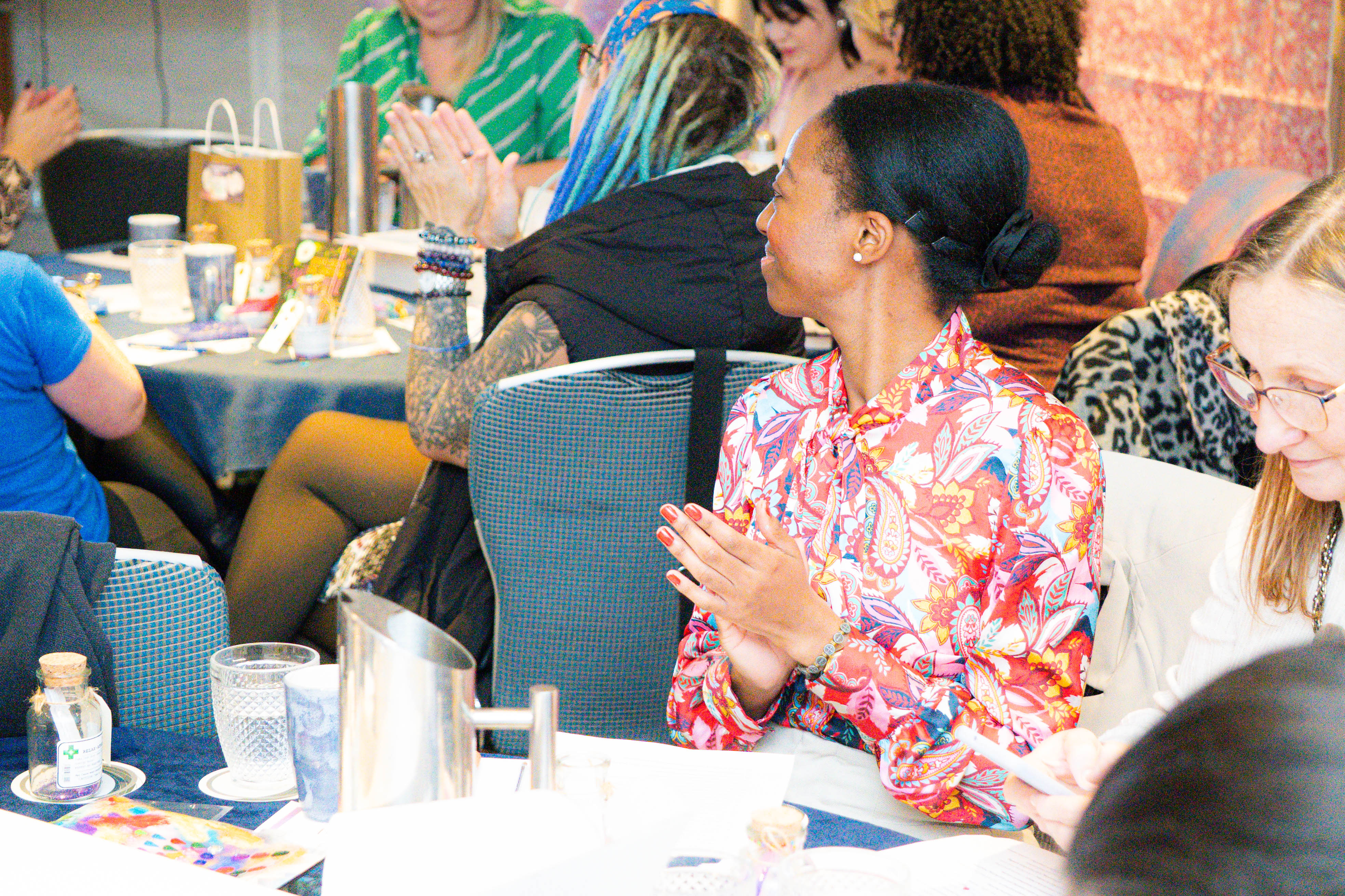 People sat clapping and smiling at Innovation celebration event