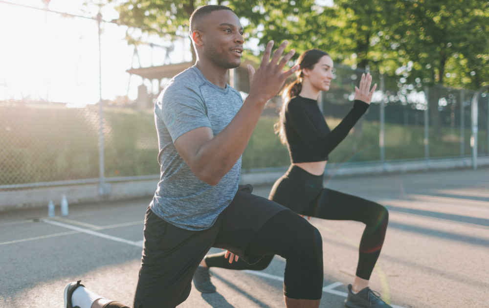 man and woman doing mobility exercises outdoors for joint health