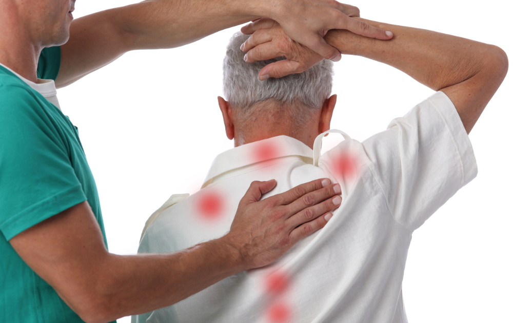 therapist applying back massage to senior man for pain relief