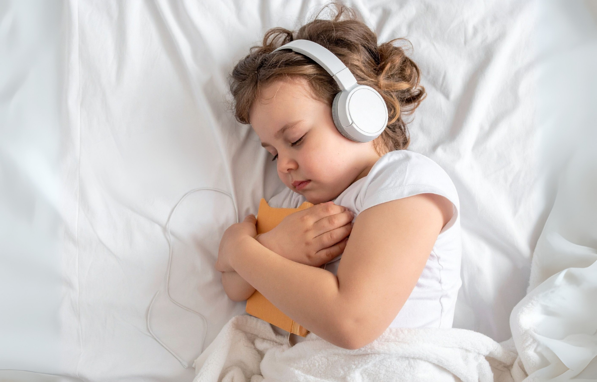 Child with sensory sensitivity sleeping with headphones