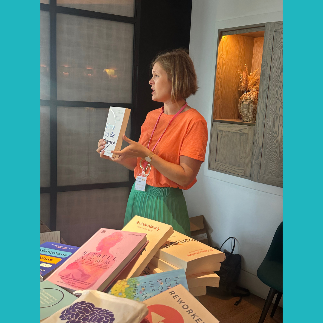 Image of Dr Claire Plumbly showcasing books by psychologists