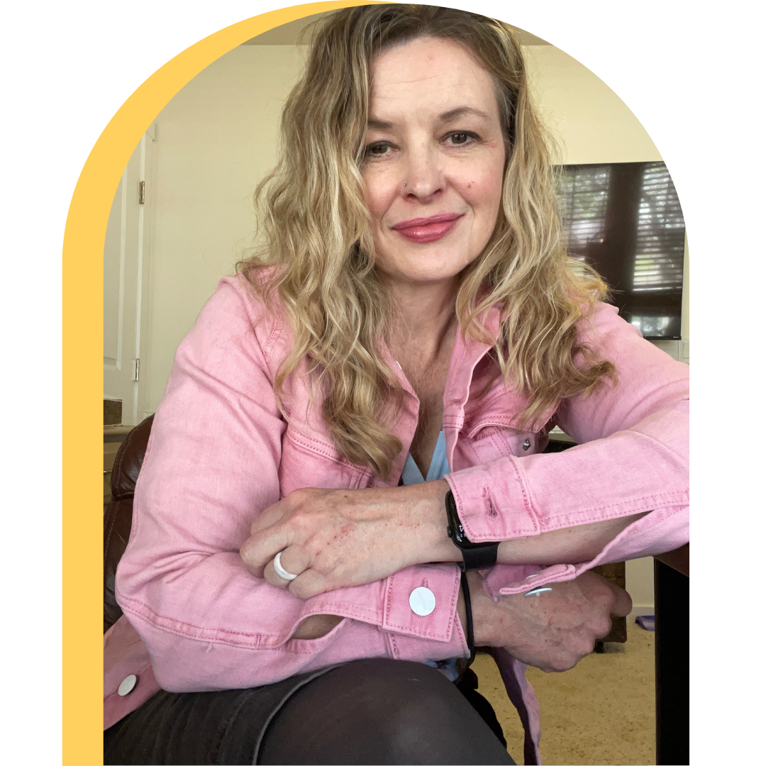 Jami Altwies, women’s health coach in pink jacket, seated and smiling