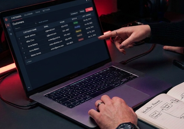 Business team reviewing customer workflow and systems on a laptop