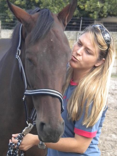 Kristen whispering to a horse