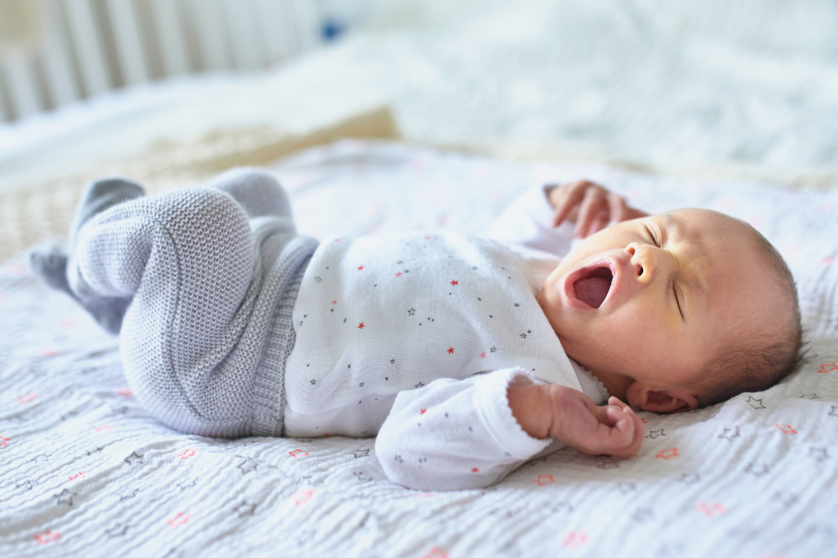 photo of a baby in blue knitted trousers and a t-shirt