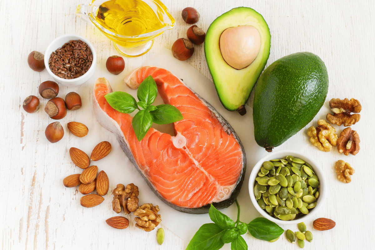 photo of omega-3 rich foods, salmon, avocado and olive oil
