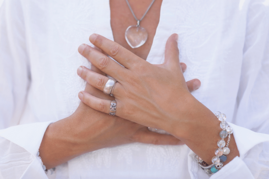 a photo of a woman holding her hands to her chest over her heart
