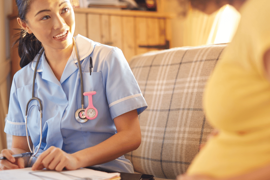 Photo of midwife talking to pregnant woman and taking notes