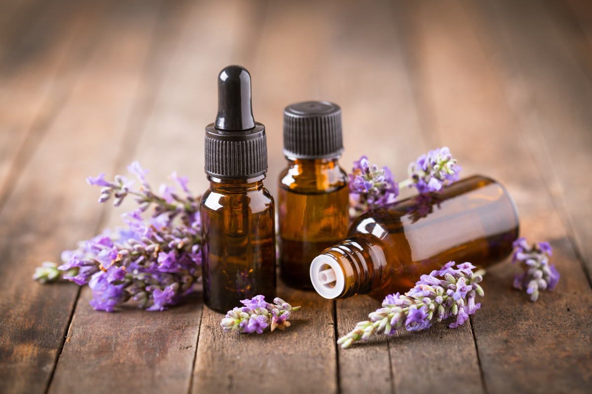 photo of brown glass bottles surrounded by lavender stems on a table