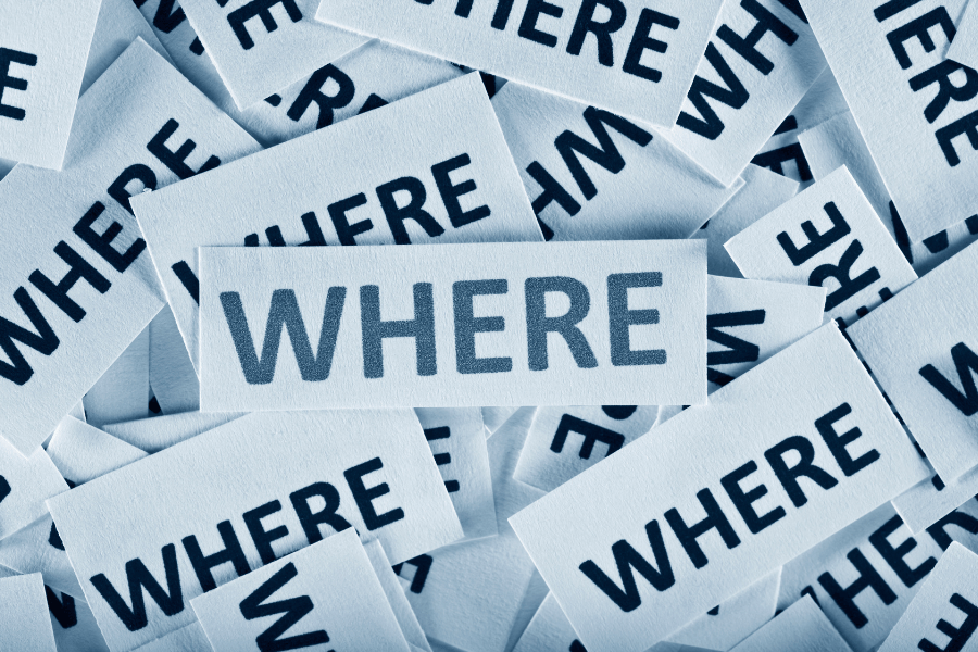 multiple pieces of white paper with black writing saying 'where?' overlapping each other