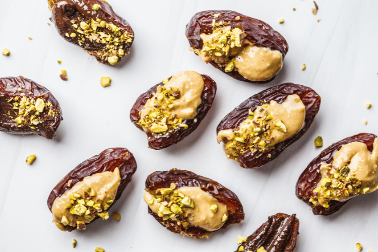 photo of dates with nut butter in the middle and a sprinkle of chopped pistachios on top